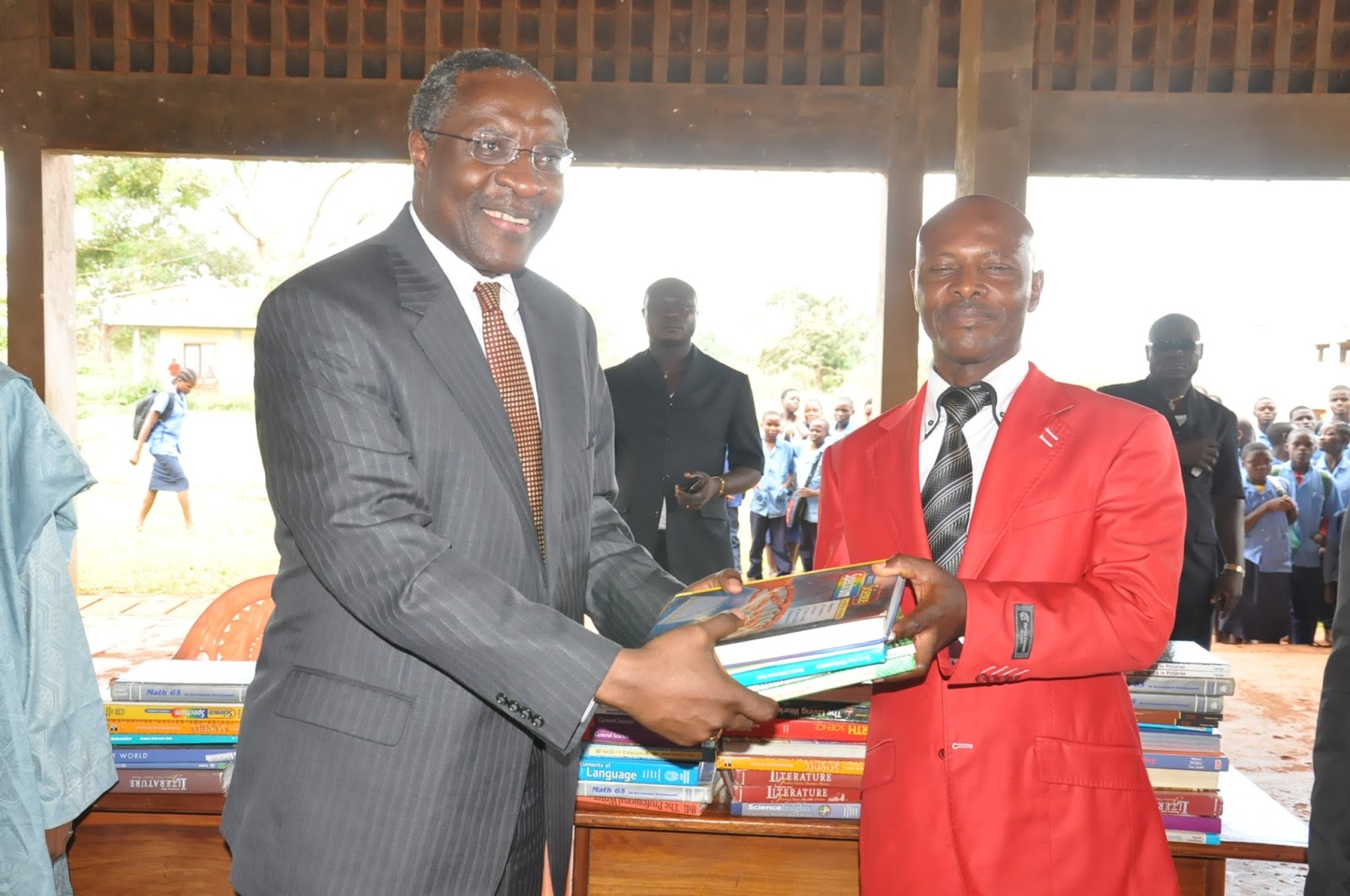 Dr. Fomunyoh donating books to Lycee Bilingue d'Abong Mbang. Right- The Principal of Lycee d'Abong Mbang