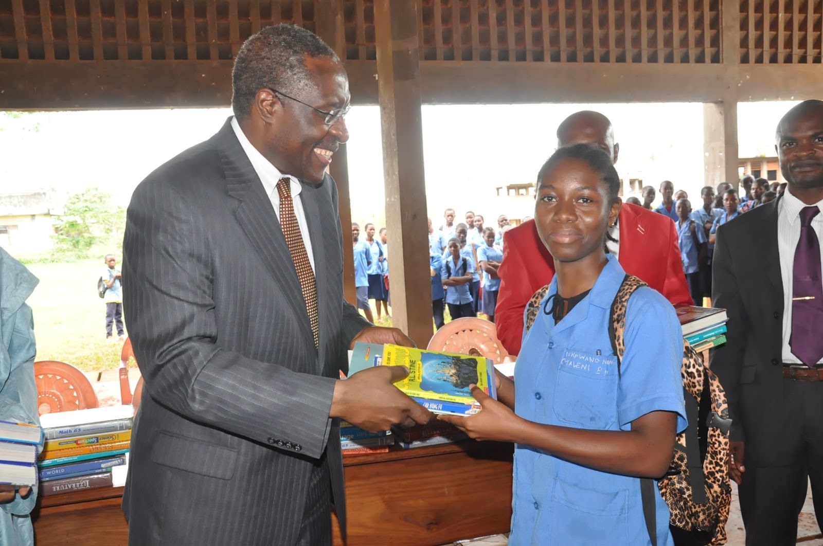 Dr. Fomunyoh handing over some donated books to a student of Lycee d'Abong Mbang